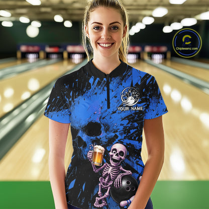 Person wearing a blue and black bowling shirt with a skeleton design in a bowling alley.
