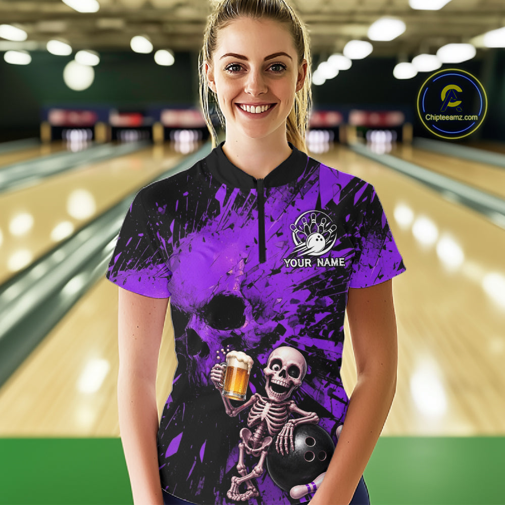 Person wearing a purple and black bowling shirt with a skeleton design in a bowling alley.
