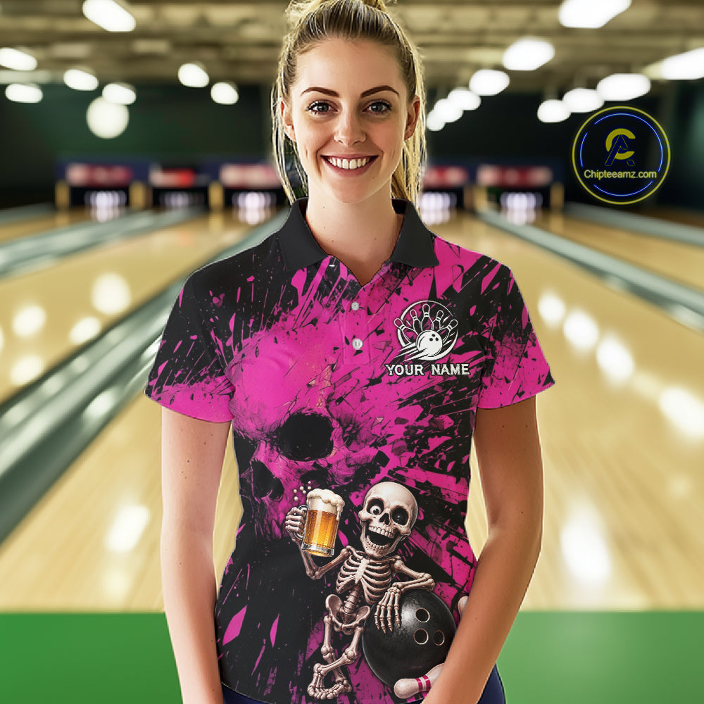 Person wearing a pink and black bowling shirt with a skeleton design in a bowling alley.