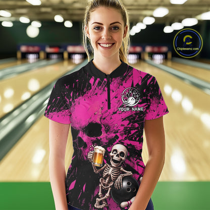 Person wearing a pink and black bowling shirt with a skeleton design in a bowling alley.