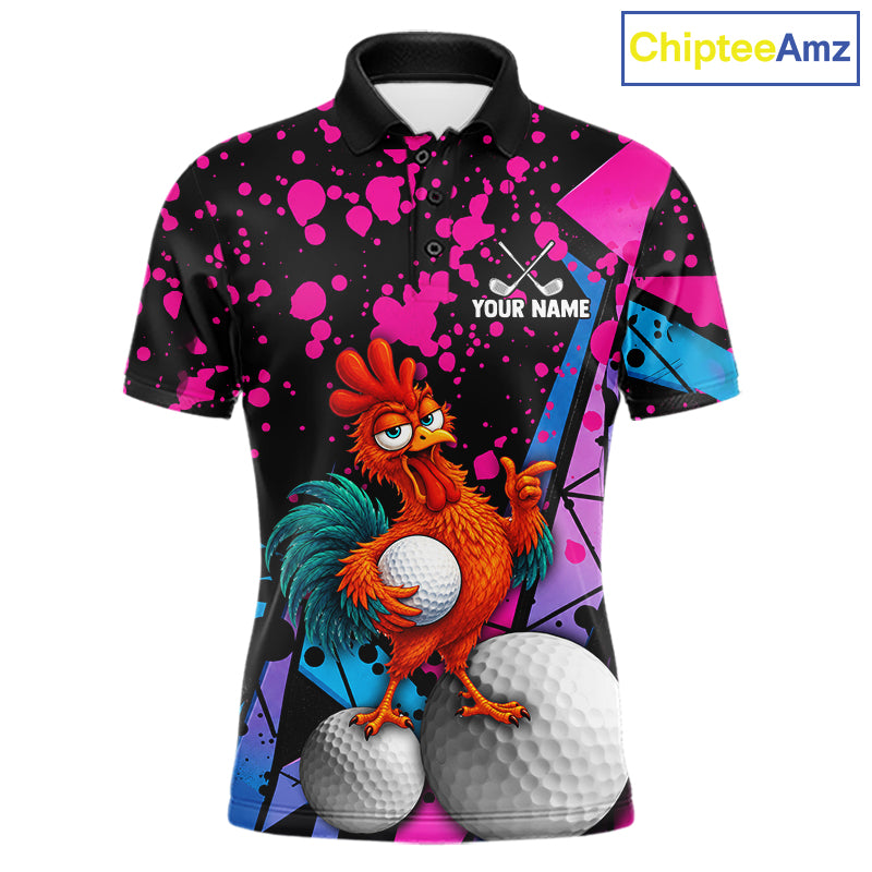 A short-sleeve polo shirt with a black base covered in bright pink, blue, and purple paint splatter graphics, featuring a cartoon rooster holding a golf ball with two golf balls at the bottom. The shirt has a black collar, a button placket, and 'YOUR NAME' printed on the chest with crossed golf clubs above it.