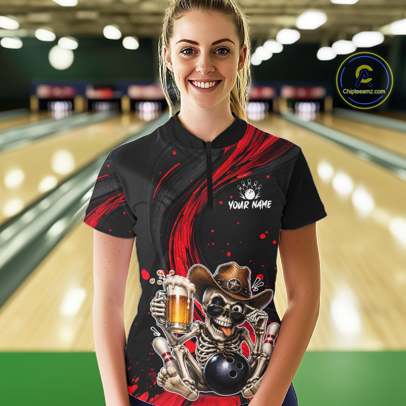 Person wearing a black and red bowling shirt with a skeleton design in a bowling alley.