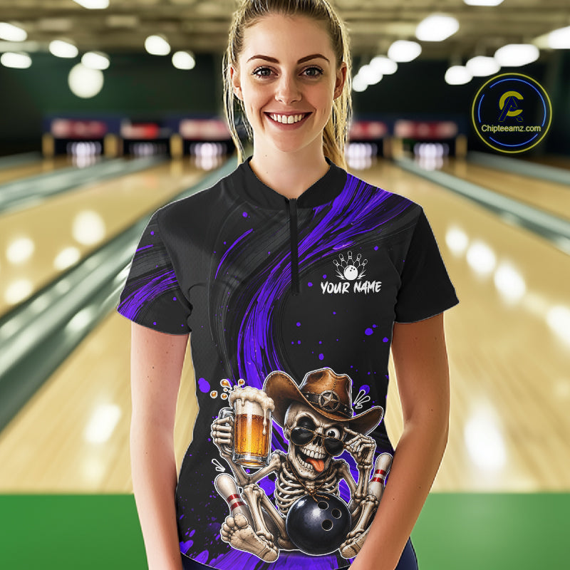 Person wearing a black and purple bowling shirt with a skeleton design in a bowling alley.