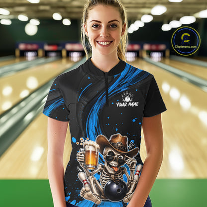 Person wearing a black and blue bowling shirt with a skeleton design in a bowling alley.