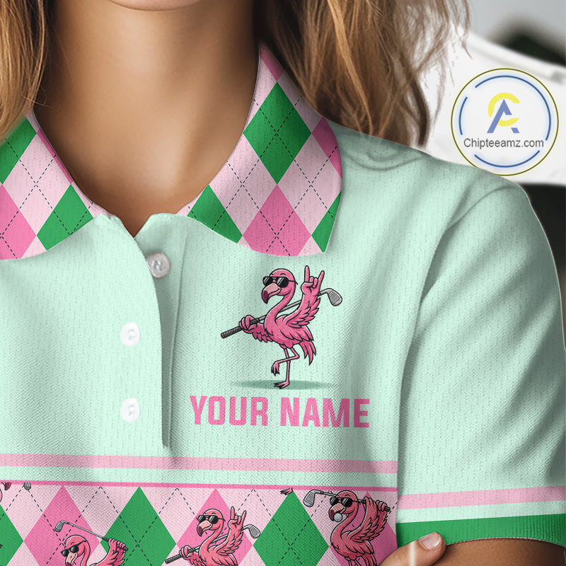A close-up of a person wearing a light mint green polo shirt with a pink and green argyle pattern on the collar and hem, featuring a pink flamingo graphic and the text 'YOUR NAME'.