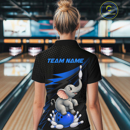 A woman viewed from behind wearing a black short-sleeve bowling-themed polo shirt with a cartoon elephant, blue bowling ball, pins, and the text 'TEAM NAME' on the back. The background shows a blurred bowling alley interior.