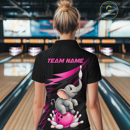 A woman viewed from behind wearing a black short-sleeve bowling-themed polo shirt with a large graphic of a cartoon elephant on a pink bowling ball and the text 'TEAM NAME' on the back. The background shows a blurred bowling alley interior.