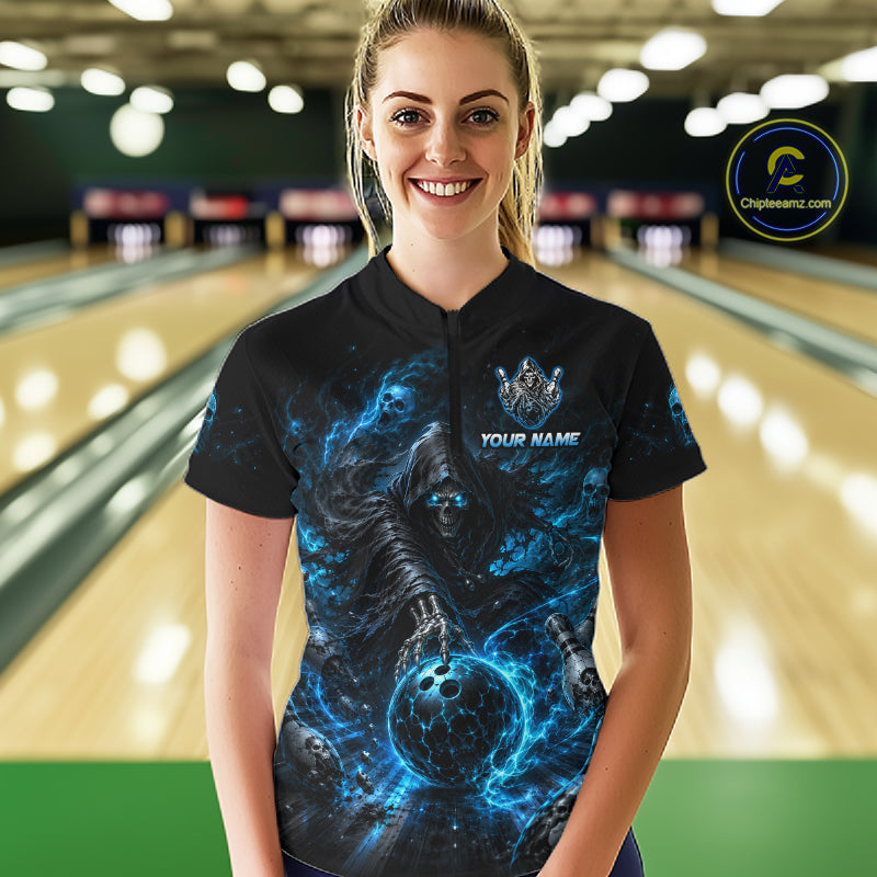 Person wearing a black t-shirt with a blue graphic design and 'TEAM NAME' text in a bowling alley.