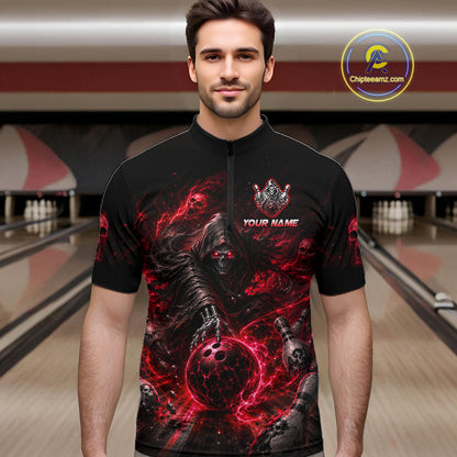 Man wearing a black bowling shirt with red and gray graphics in a bowling alley.