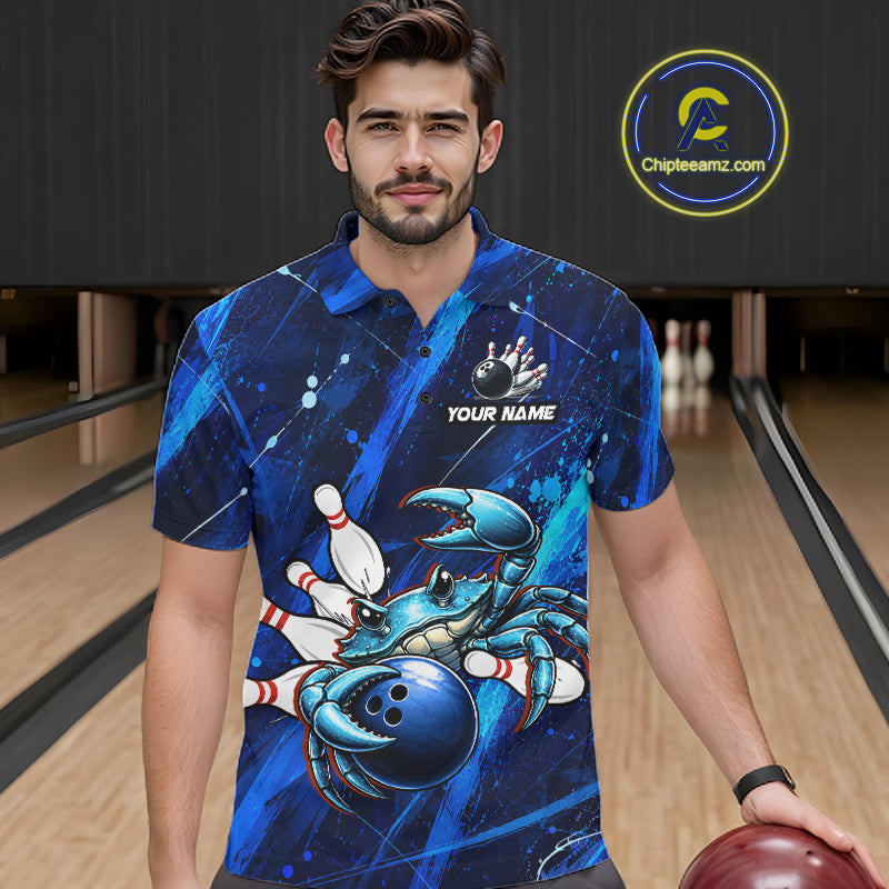 Man wearing a blue bowling-themed shirt with a crab design in a bowling alley.