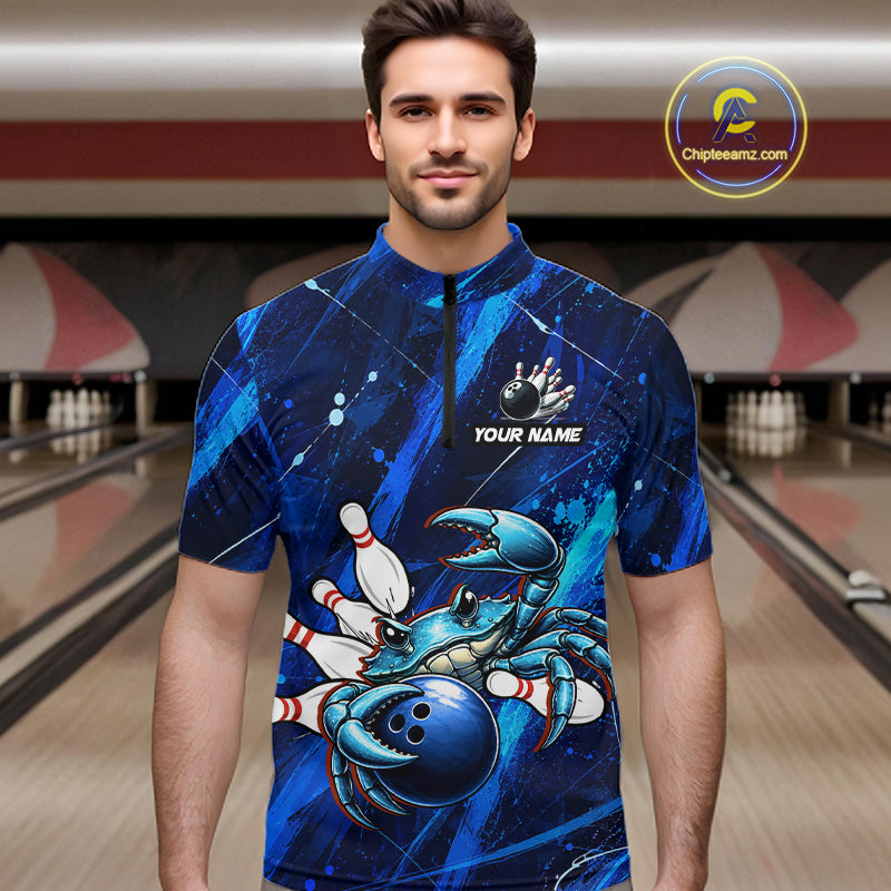 Man wearing a blue bowling jersey with a crab design in a bowling alley.