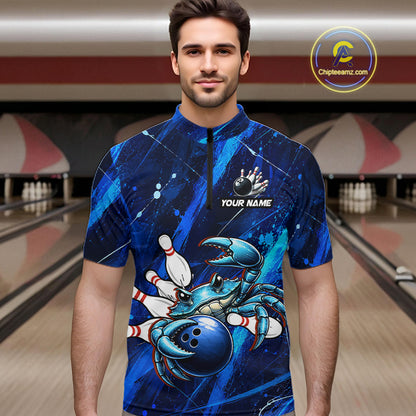 Man wearing a blue bowling jersey with a crab design in a bowling alley.