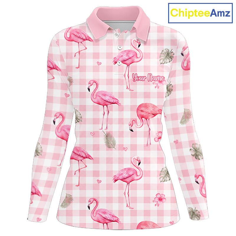 A long-sleeve women's polo shirt with a pink and white gingham pattern, decorated with pink flamingos, palm leaves, and small hearts. The shirt features a pink collar and a customizable text placeholder 'Your Name' printed on the chest.