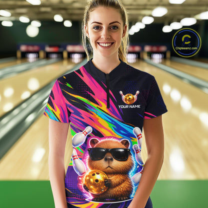 erson wearing a colorful bowling shirt with a bear design in a bowling alley.