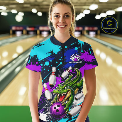 Person wearing a colorful bowling shirt with a dragon design in a bowling alley.