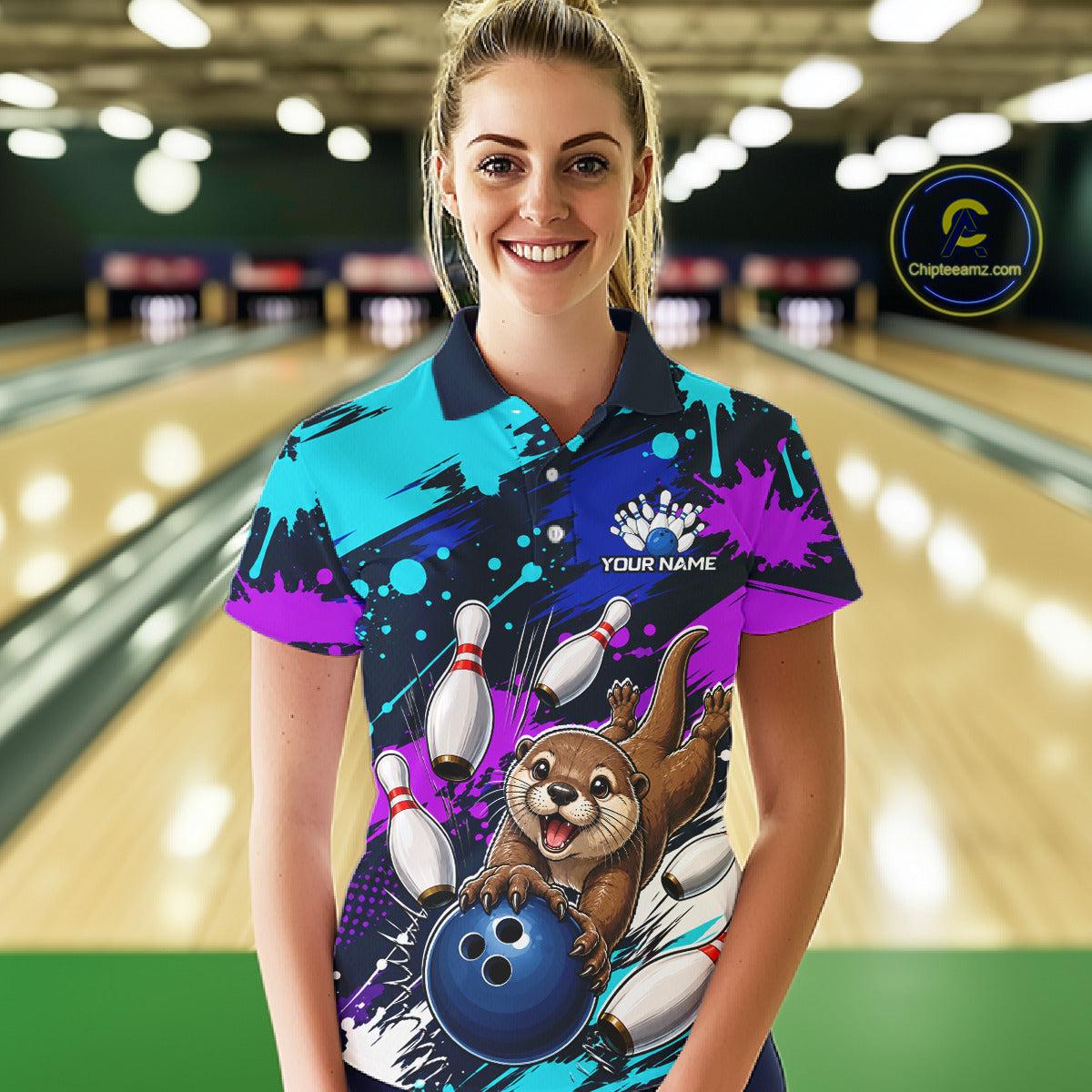 Woman wearing a colorful bowling shirt with an otter and bowling ball design in a bowling alley.