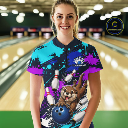 Person wearing a colorful bowling jersey with an otter and bowling ball design in a bowling alley.
