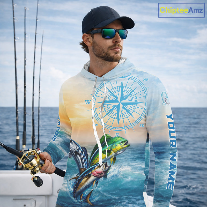 Angler wearing mahi mahi wahoo tuna blue hooded performance fishing shirt on boat with custom name on sleeves