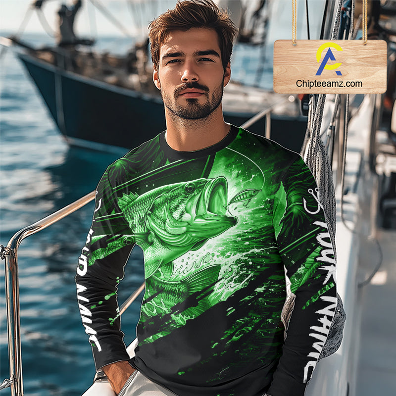 Man wearing a long sleeve fishing shirt with a green bass fish design on a boat