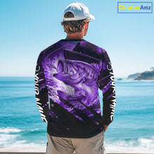 Load image into Gallery viewer, Person wearing a purple and black bass fishing shirt with a fish design, standing by the ocean.