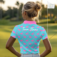 Load image into Gallery viewer, Woman wearing a turquoise polo shirt with pink flamingo pattern and 'Team Name' text on the back, standing on a golf course.