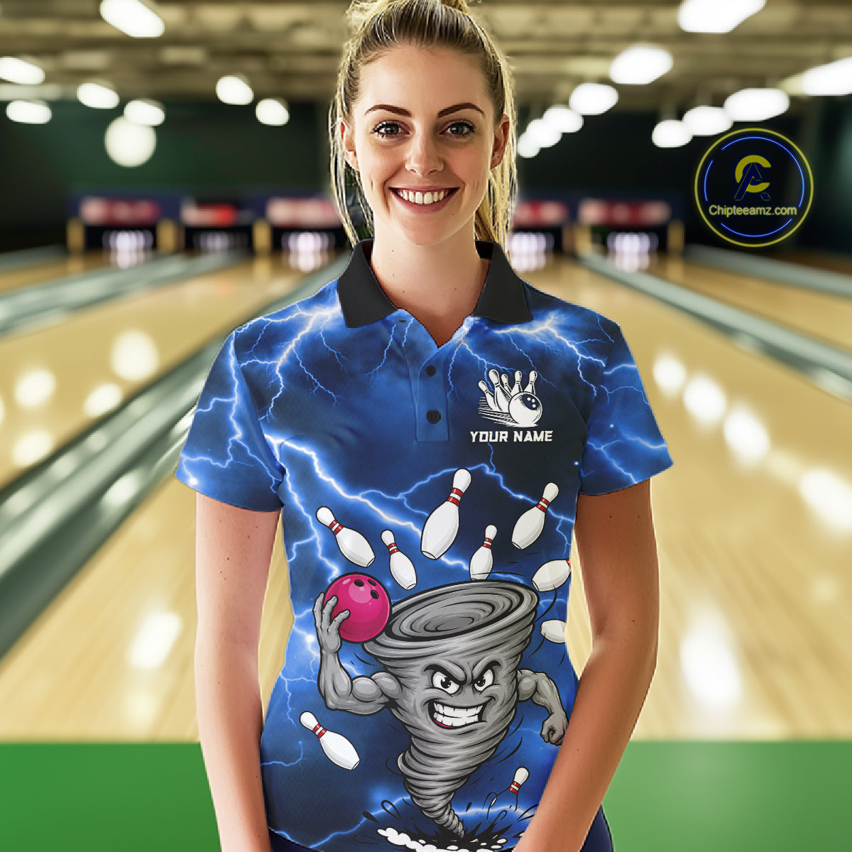 Woman wearing a blue thunder lightning tornado bowling polo shirt at a bowling alley front view.