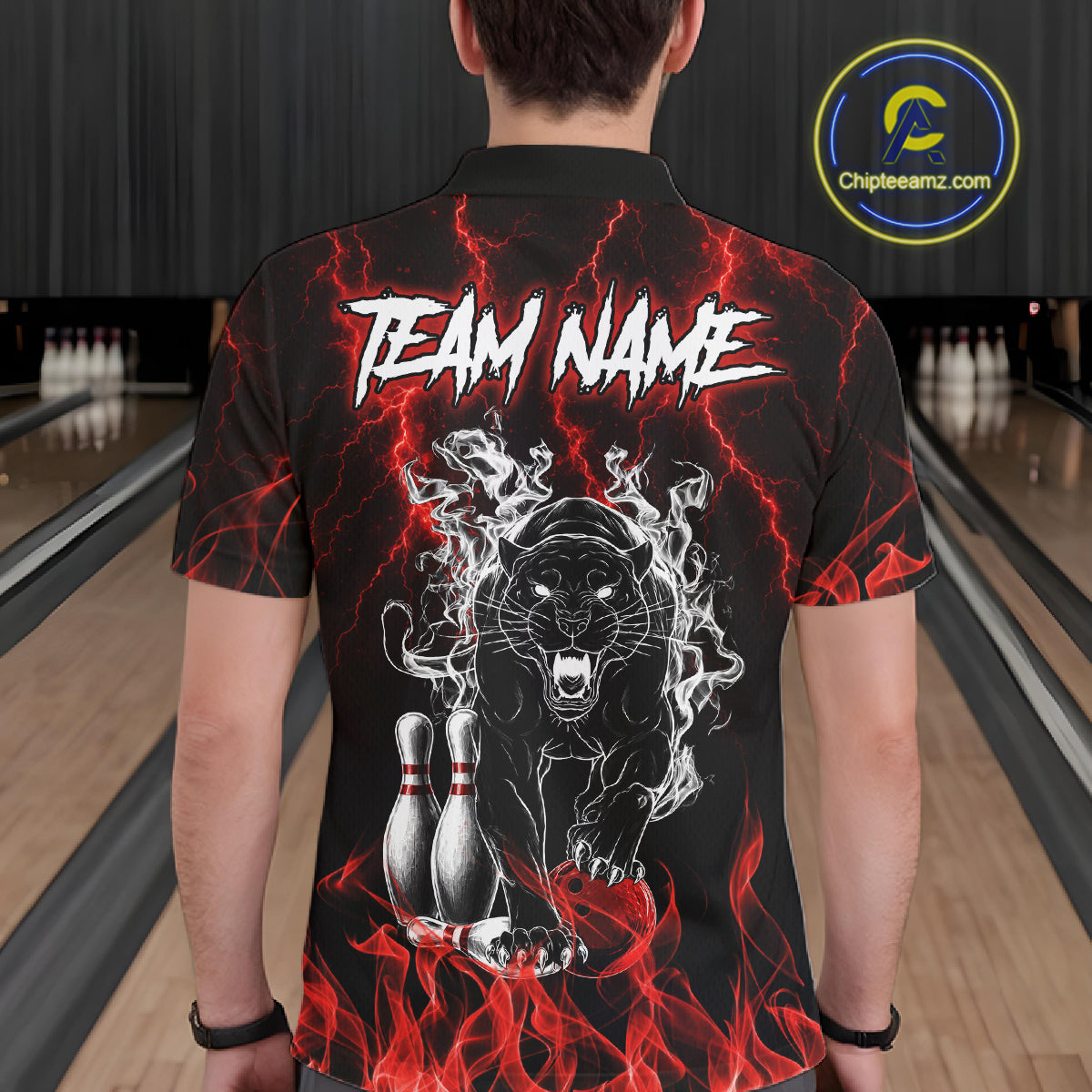 Back view of man wearing a red flaming panther bowling polo shirt inside a bowling alley.