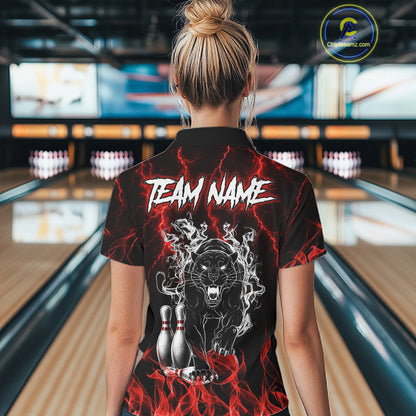 Back view of woman wearing a red flaming panther bowling polo shirt inside a bowling alley.