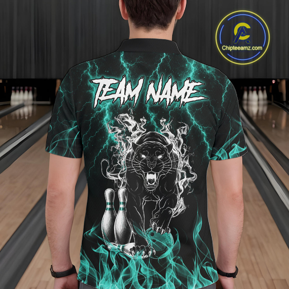 Back view of man wearing a turquoise flaming panther bowling polo shirt inside a bowling alley.