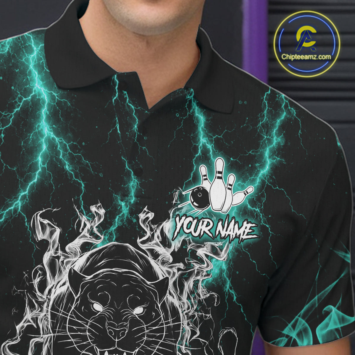 Close-up of a turquoise flaming panther bowling polo shirt collar, buttons, and panther artwork details.