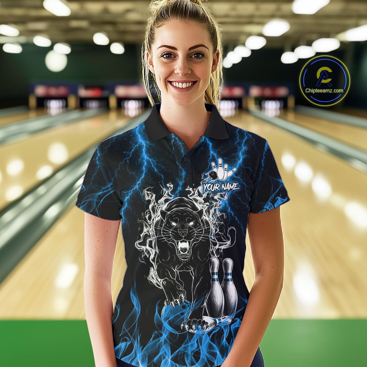 Woman wearing a blue flaming panther bowling polo shirt at a bowling alley front view.