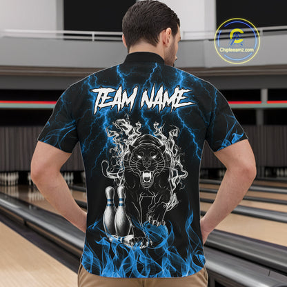 Back view of man wearing a blue flaming panther bowling quarter zip shirt in a bowling alley.