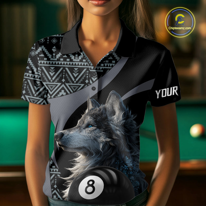Man holding a pool cue with a shirt featuring a wolf design and number 8 on a pool table.