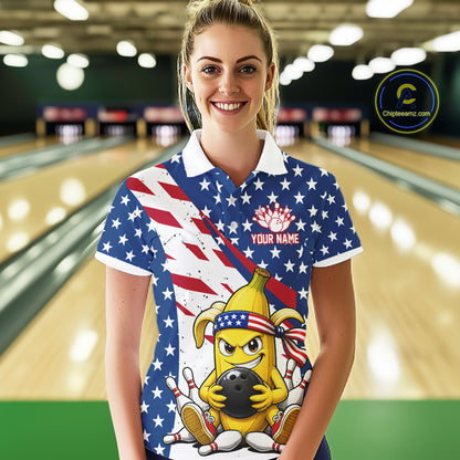 Woman wearing a patriotic-themed polo shirt with a banana cartoon character holding a bowling ball in a bowling alley.