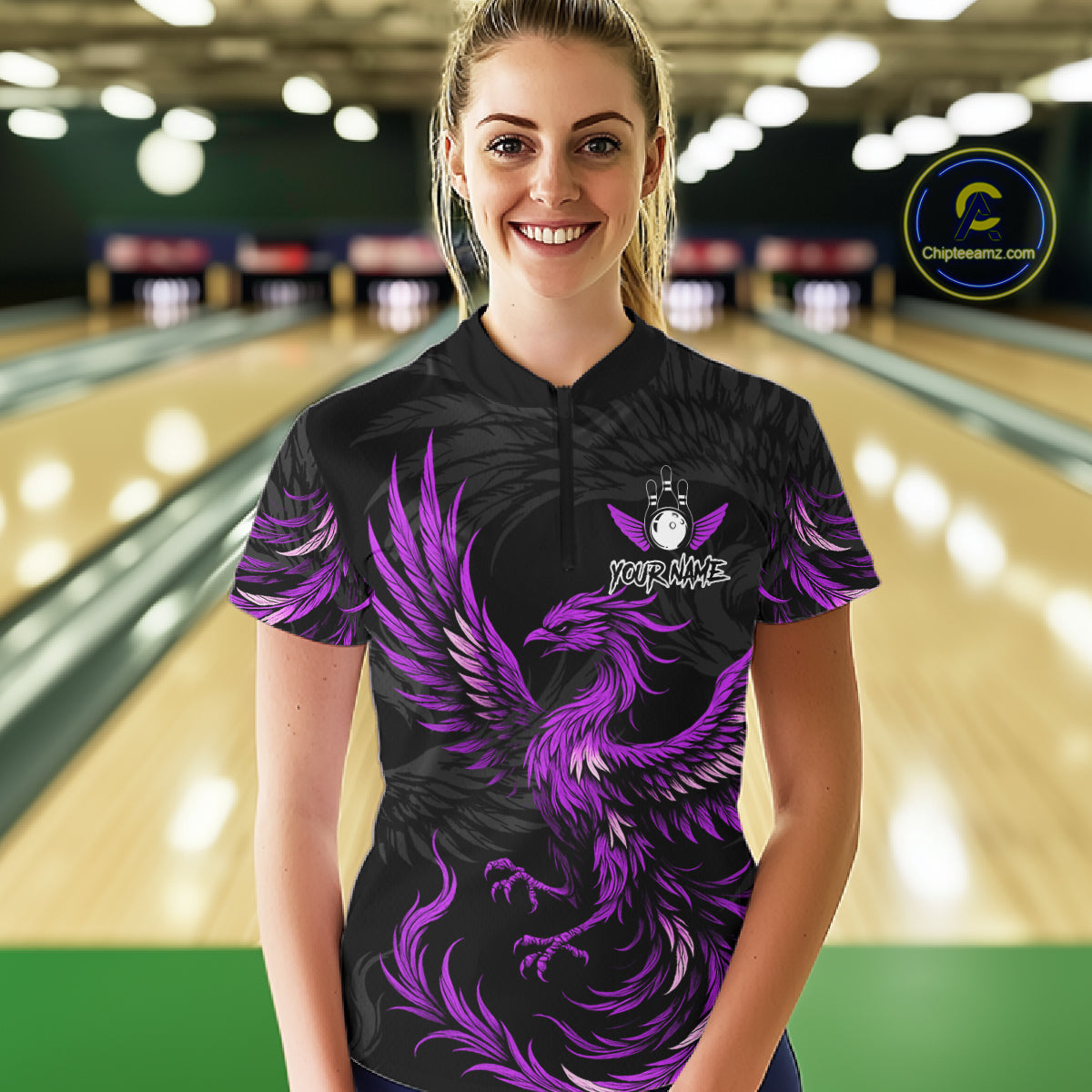 Woman wearing black and purple phoenix wings bowling quarter zip shirt front view.