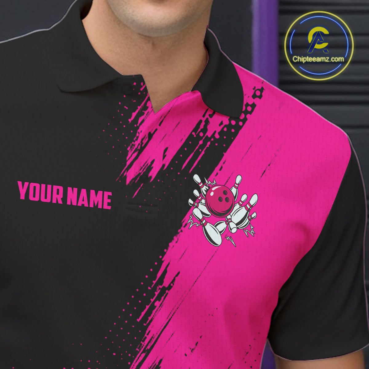 Close-up of the men's Custom Pink and Black Strike Bowling polo shirt showing the collar, button placket, chest artwork and premium performance fabric