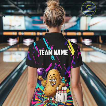 Back view of woman wearing a colorful potato bowling polo shirt inside a bowling alley.
