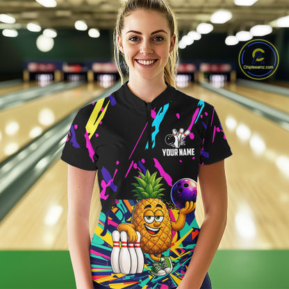 Woman wearing a colorful pineapple bowling polo shirt at a bowling alley front view.
