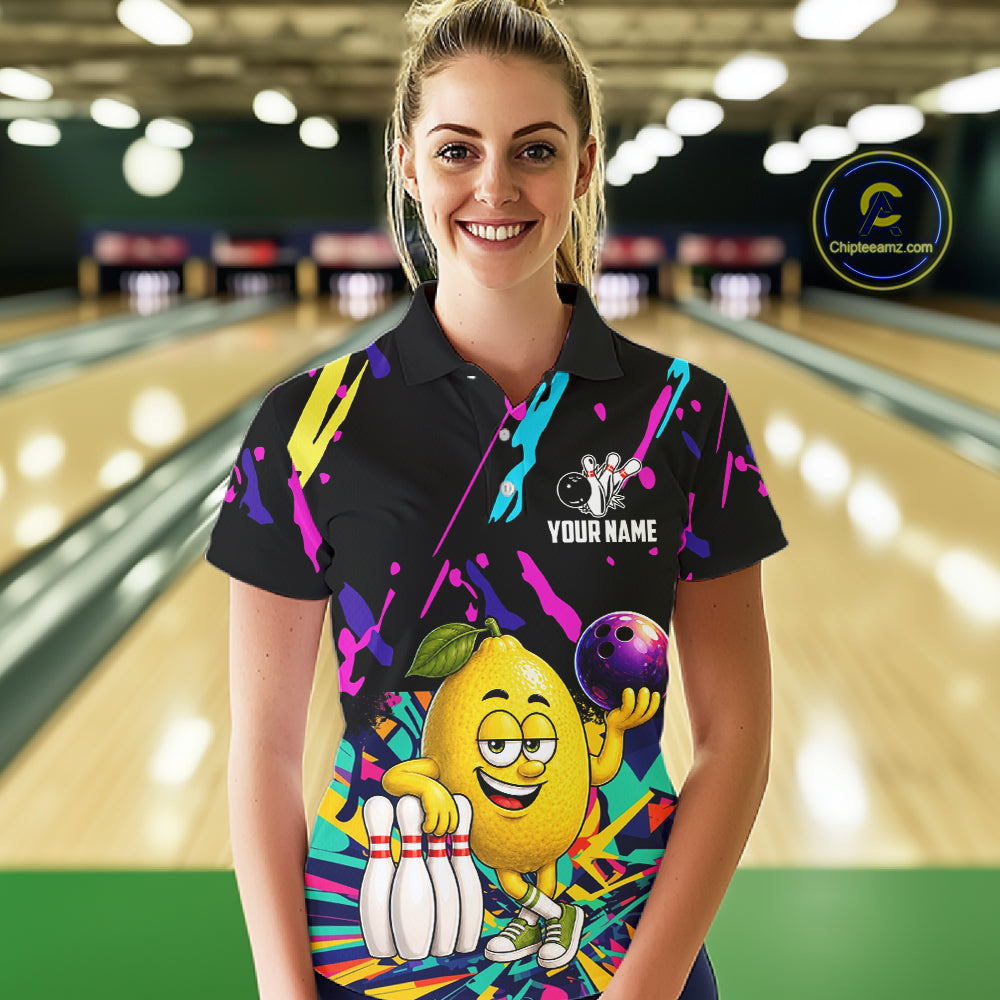 Woman wearing a colorful lemon bowling polo shirt at a bowling alley front view.
