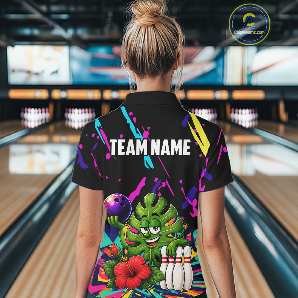 Back view of woman wearing a colorful sunflower bowling polo shirt inside a bowling alley.
