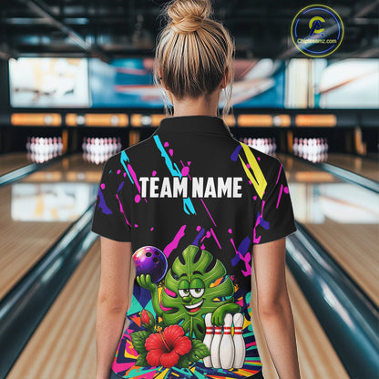Back view of woman wearing a colorful sunflower bowling polo shirt inside a bowling alley.