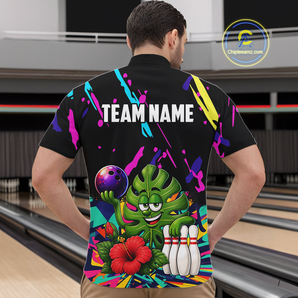 Back view of man wearing a colorful monstera hibiscus bowling quarter zip shirt in a bowling alley.