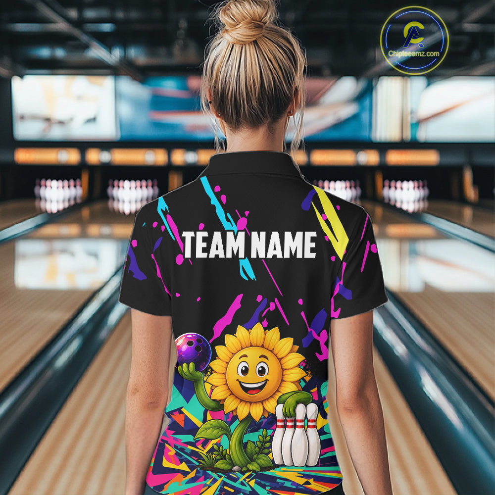 Back view of woman wearing a colorful sunflower bowling polo shirt inside a bowling alley.