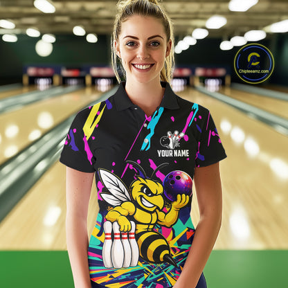 Woman wearing a colorful bowling-themed shirt with a bee graphic in a bowling alley.