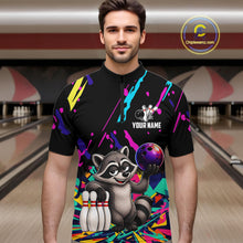 Load image into Gallery viewer, Person wearing a colorful bowling-themed shirt with a raccoon design in a bowling alley.