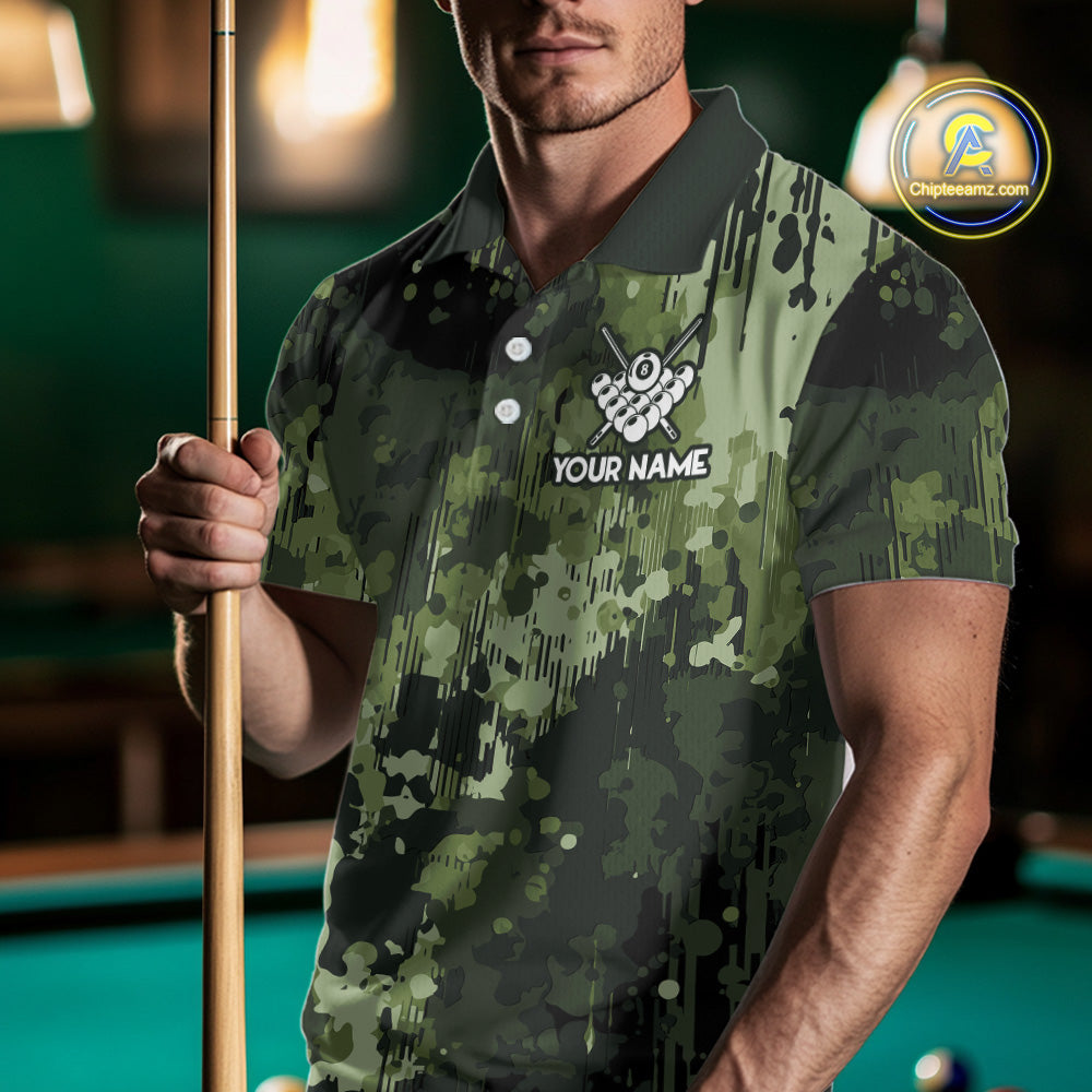 Man wearing a green camo American flag billiard jersey beside a pool table front view.