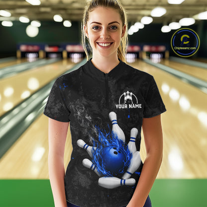 Woman wearing black and blue grunge fire bowling quarter zip shirt front view.