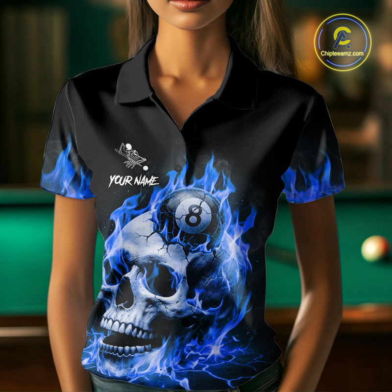 Woman wearing a blue flaming skull 8 ball and 9 ball billiard jersey beside a pool table front view.