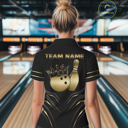 Back view of woman wearing a black and gold crown bowling ball polo shirt inside a bowling alley.