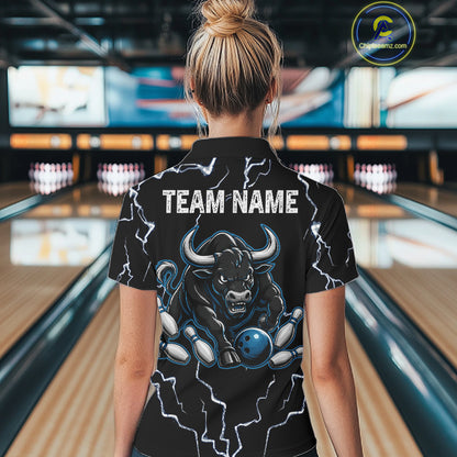 Back view of woman wearing a blue bull lightning bowling polo shirt inside a bowling alley.